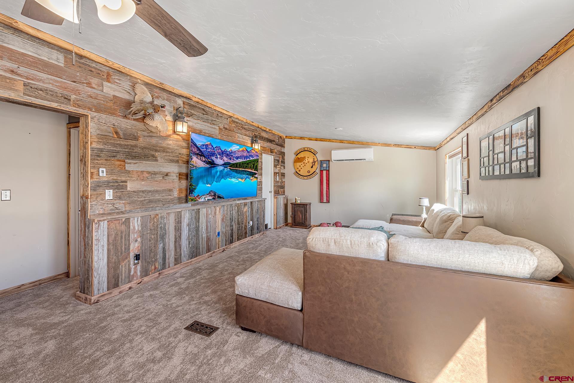 2787 2100th Road Delta, CO 81416 - Photo 7 of 40 a living room with furniture and a flat screen tv