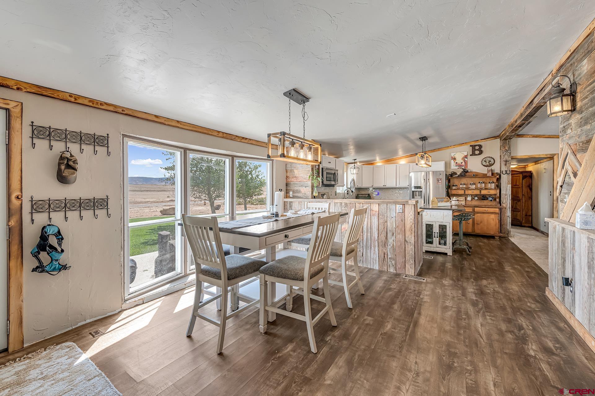 2787 2100th Road Delta, CO 81416 - Photo 10 of 40 a dining room with furniture and wooden floor