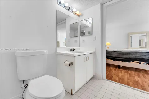 a bathroom with a sink mirror vanity and toilet