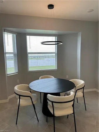 a dining room table chairs and window