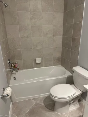 a bathroom with a toilet bathtub and shower