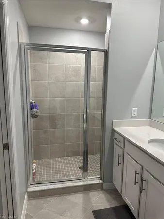 a bathroom with a shower and a sink