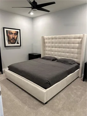a bedroom with a bed and ceiling fan