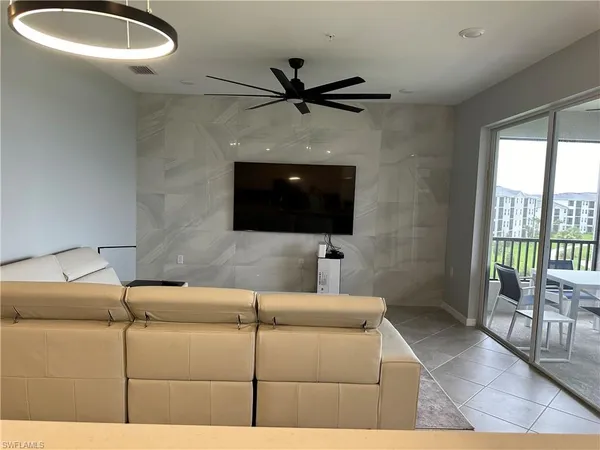 a living room with couch and a flat screen tv