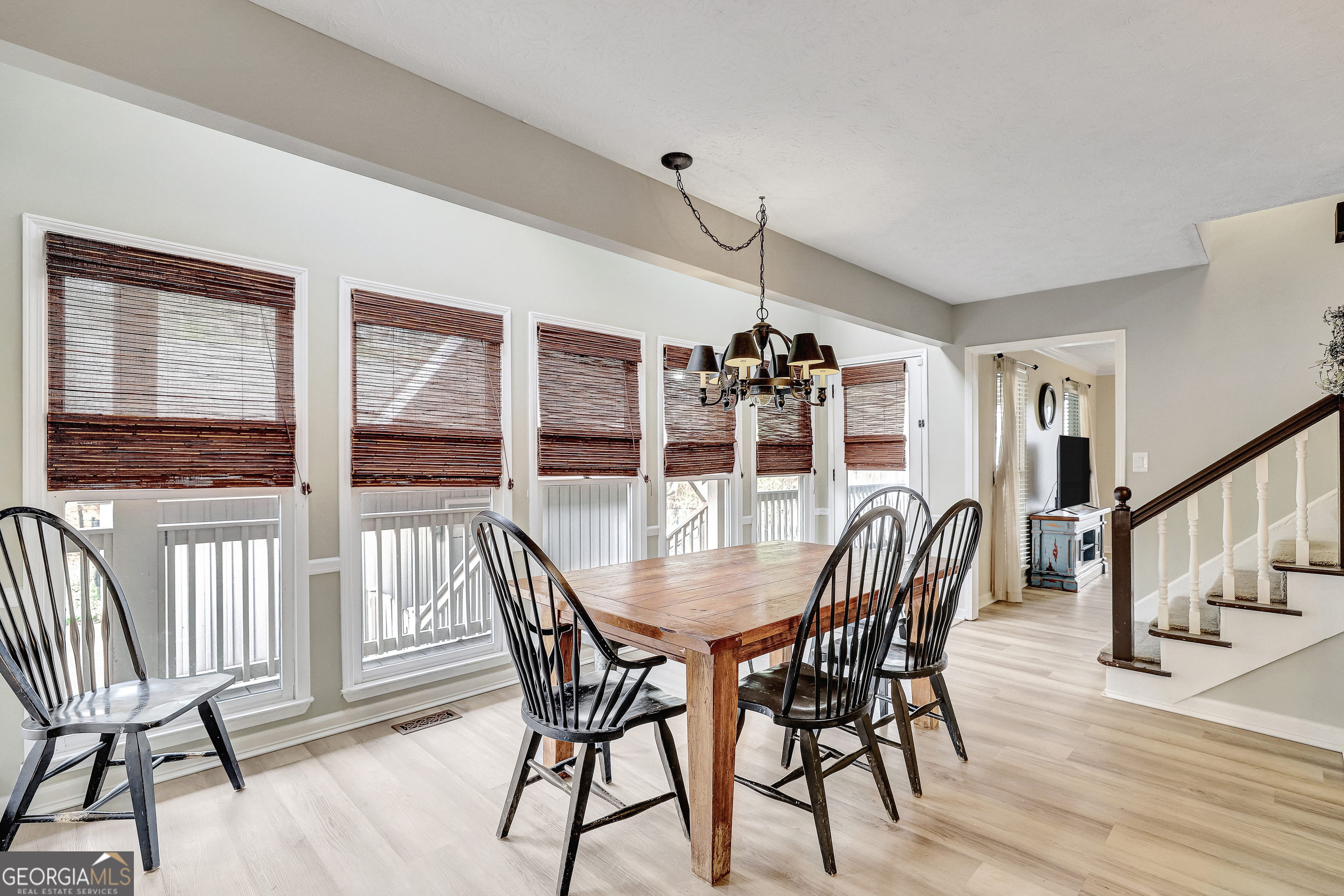 300 Briarwood Road Tyrone, GA 30290 - Photo 12 of 74 a dining room with furniture a chandelier and wooden floor