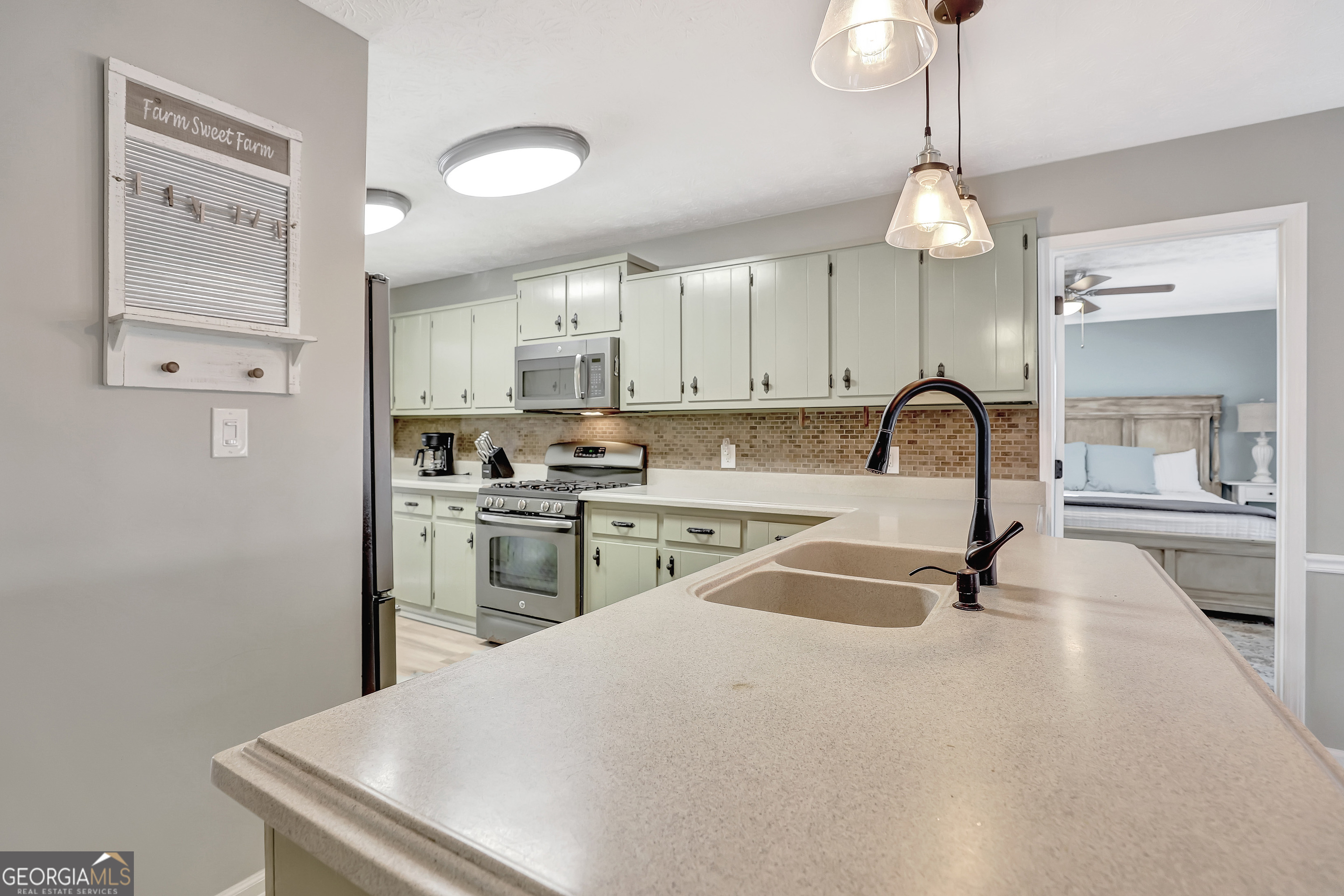 300 Briarwood Road Tyrone, GA 30290 - Photo 14 of 74 a kitchen with a refrigerator a sink and a stove