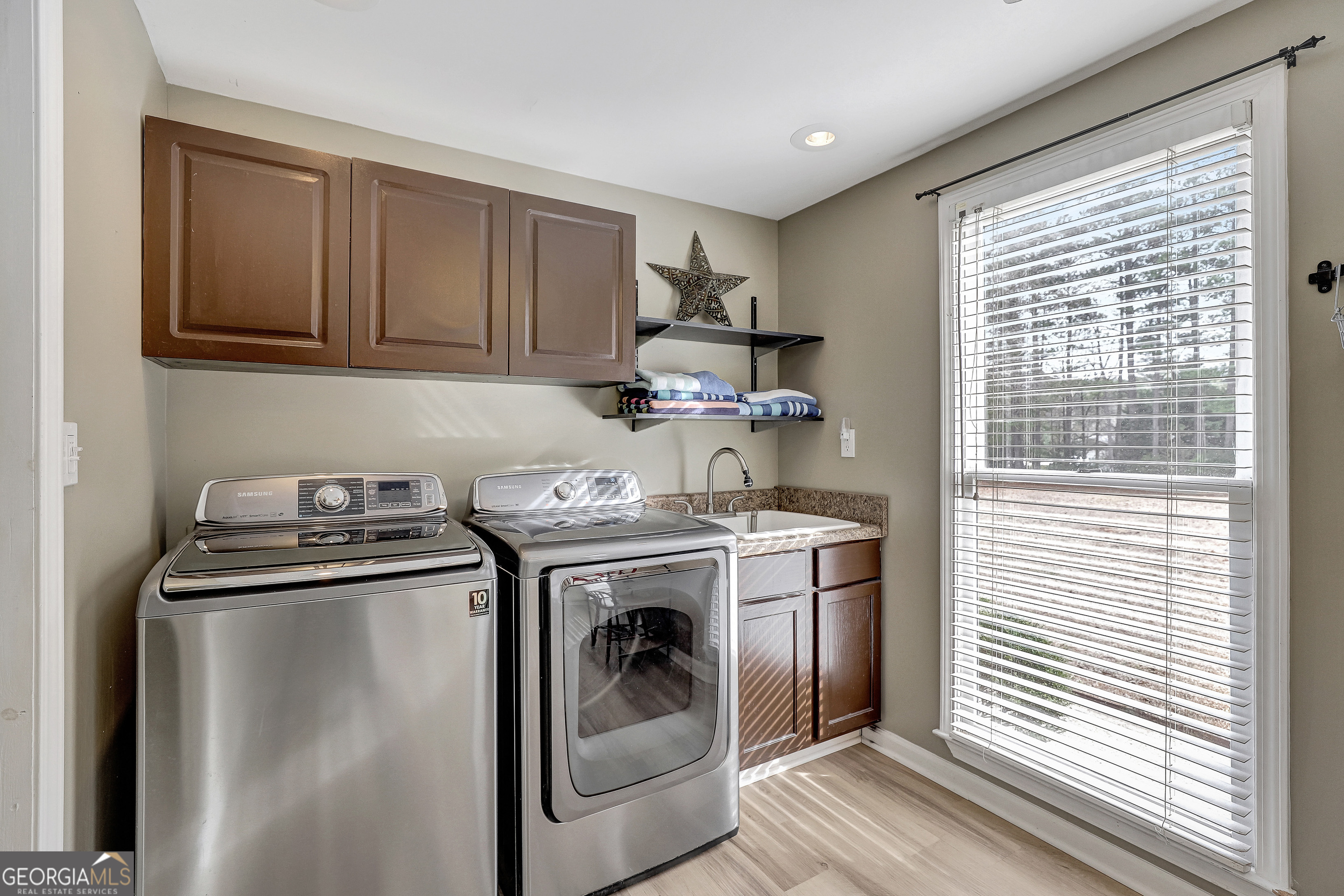 300 Briarwood Road Tyrone, GA 30290 - Photo 19 of 74 a kitchen with a stove and a sink