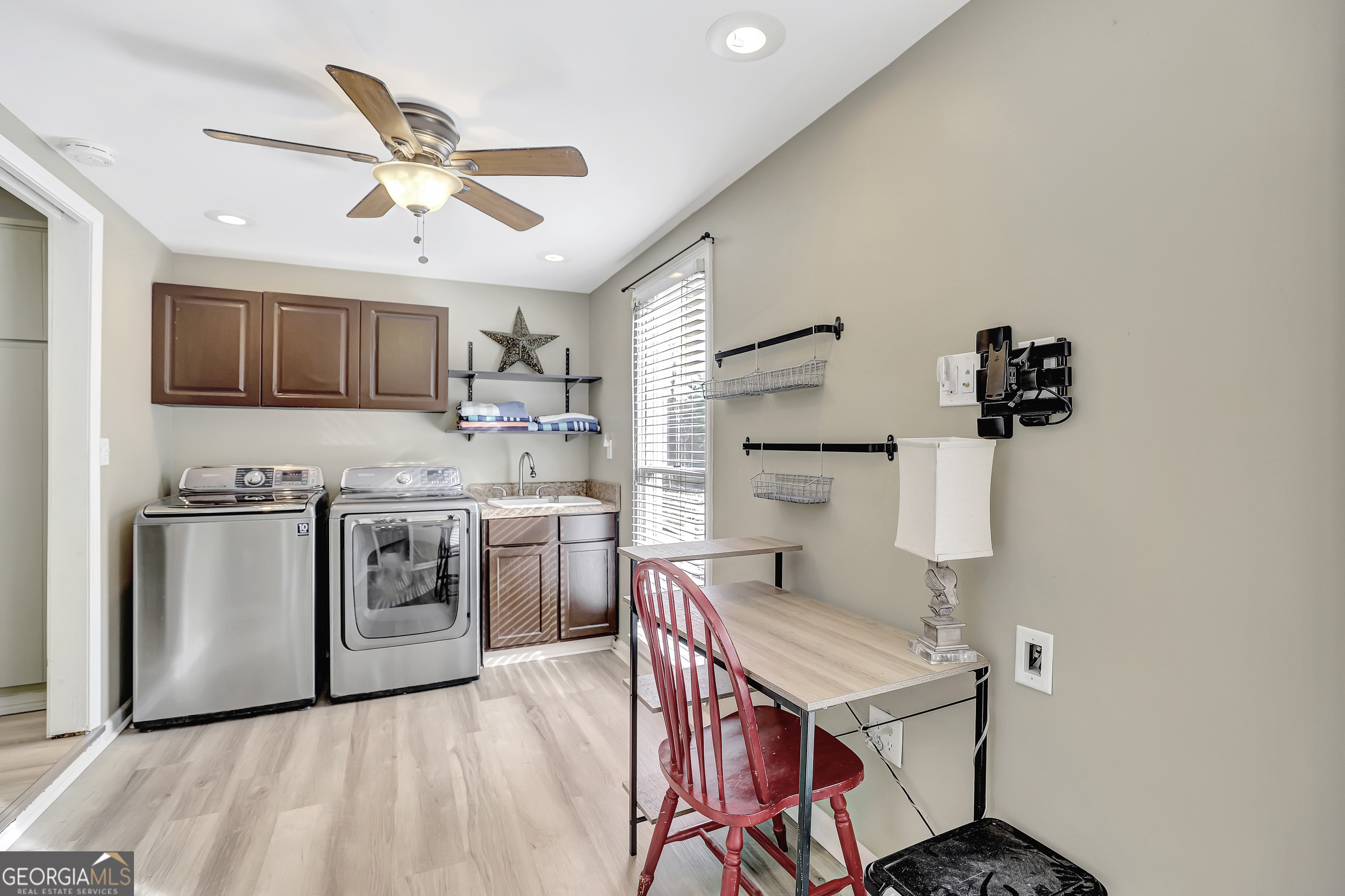 300 Briarwood Road Tyrone, GA 30290 - Photo 21 of 74 a kitchen with cabinets wooden floor and stainless steel appliances