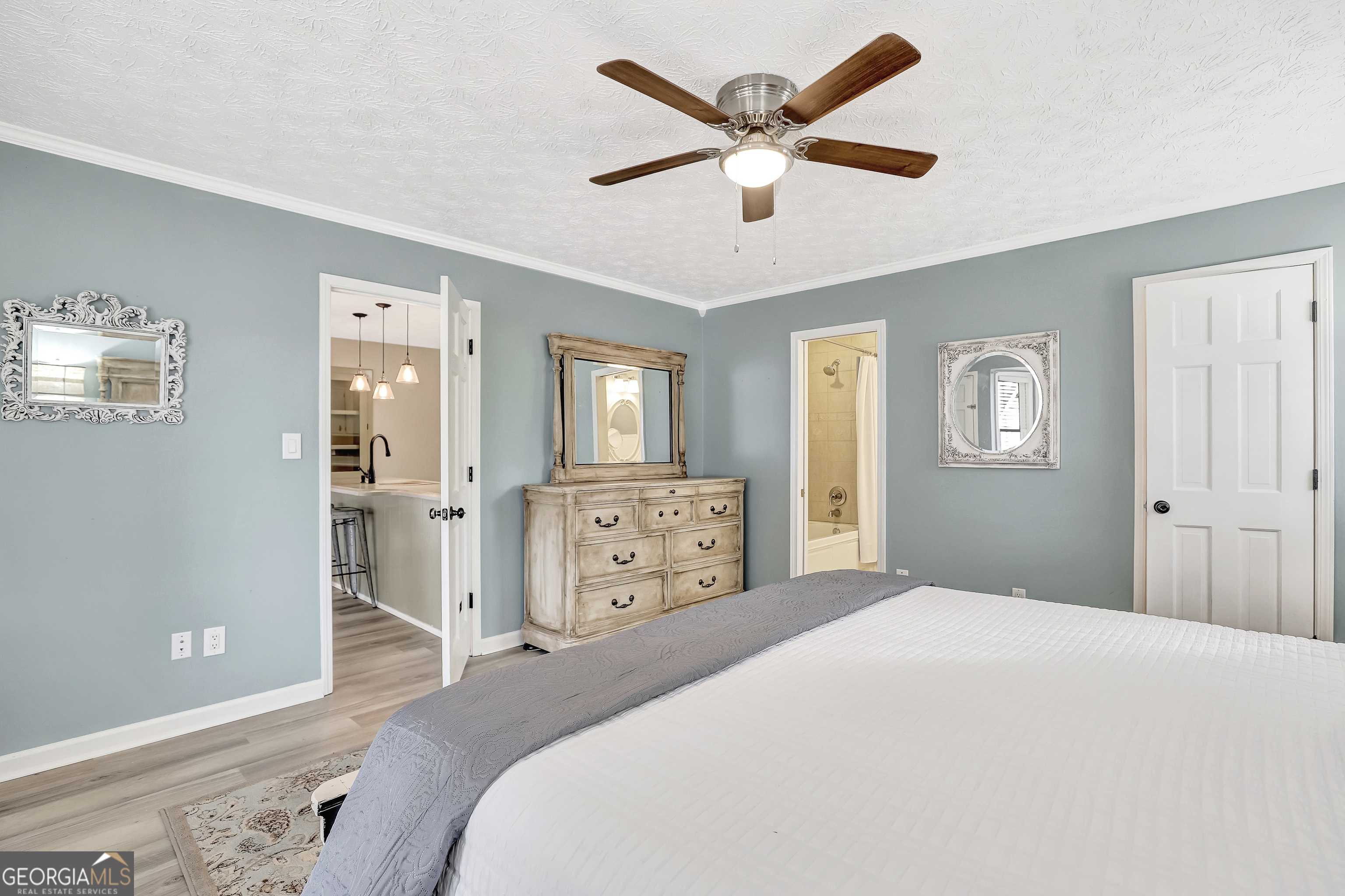 300 Briarwood Road Tyrone, GA 30290 - Photo 23 of 74 a bedroom with a large bed and a chandelier