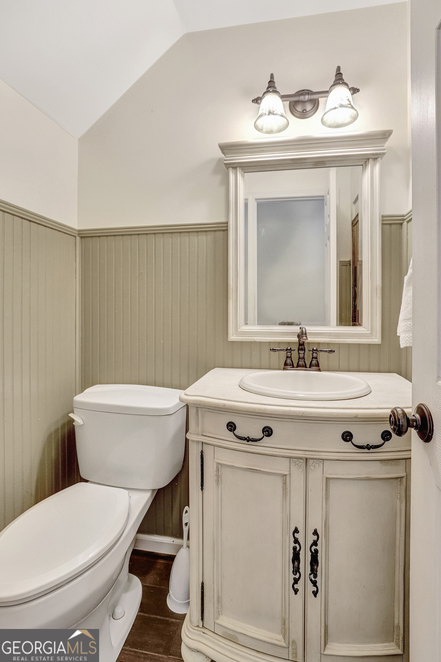 300 Briarwood Road Tyrone, GA 30290 - Photo 28 of 74 a bathroom with a sink a toilet and mirror