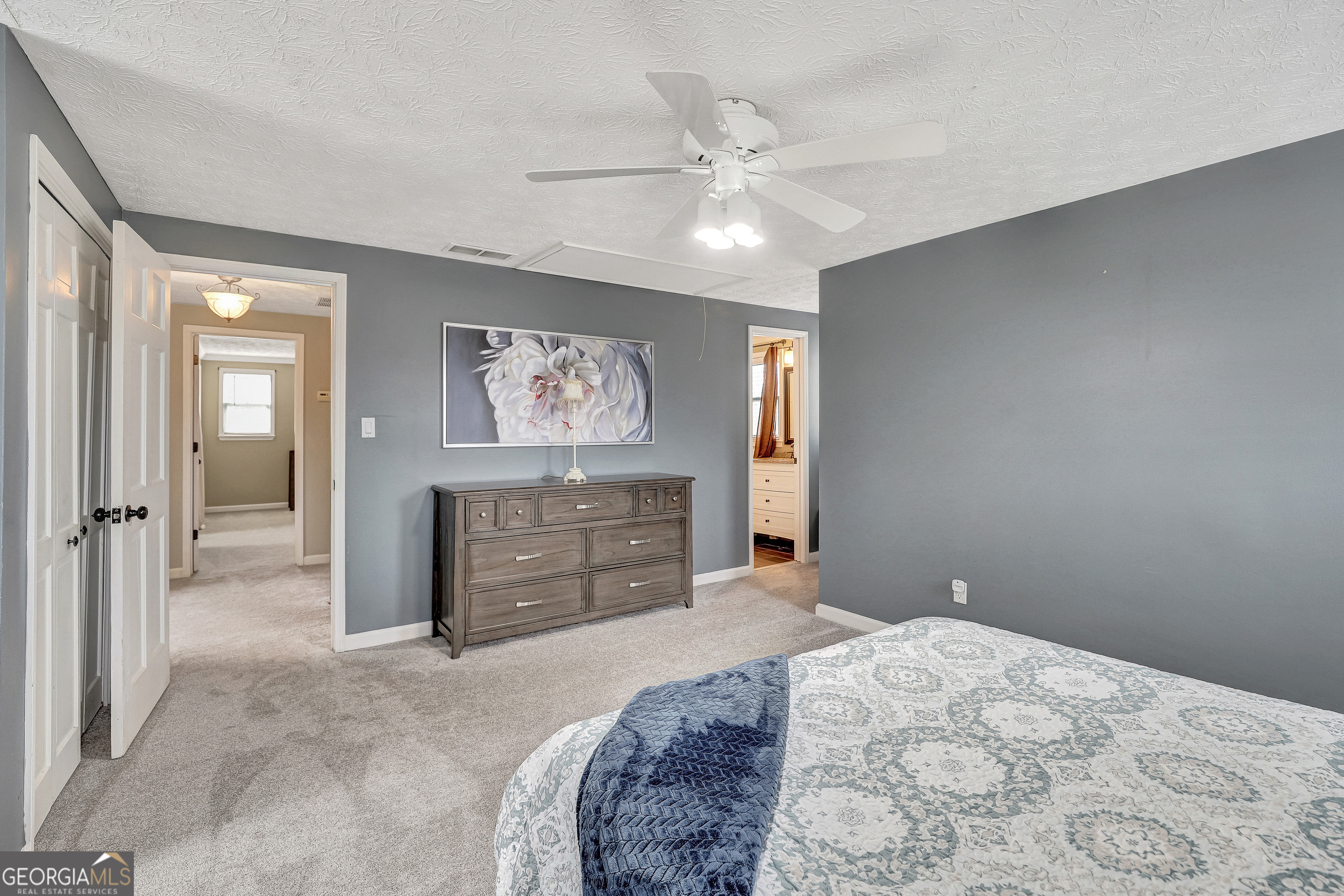 300 Briarwood Road Tyrone, GA 30290 - Photo 30 of 74 a bedroom with a bed and a chandelier