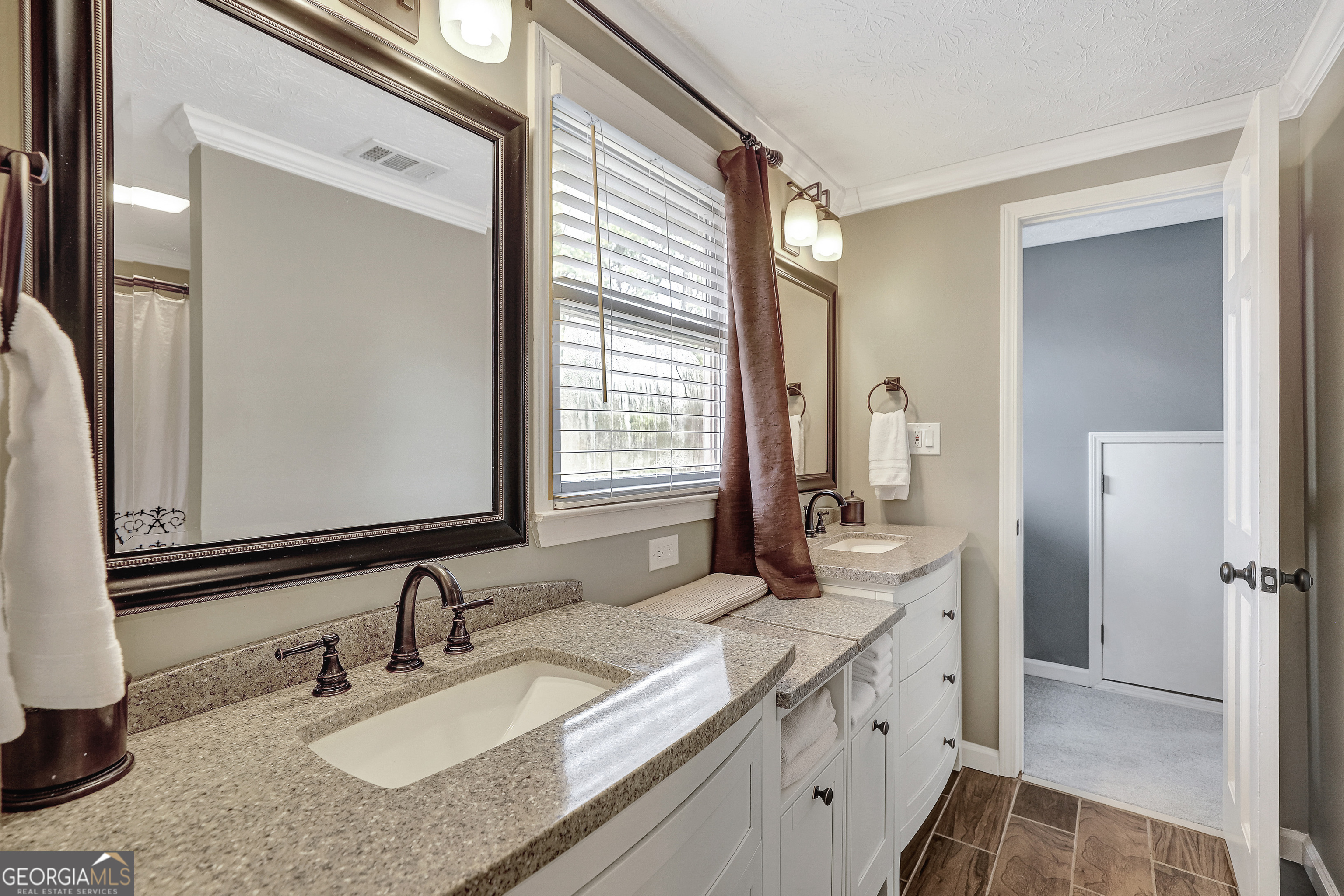 300 Briarwood Road Tyrone, GA 30290 - Photo 34 of 74 a bathroom with a granite countertop sink and a mirror