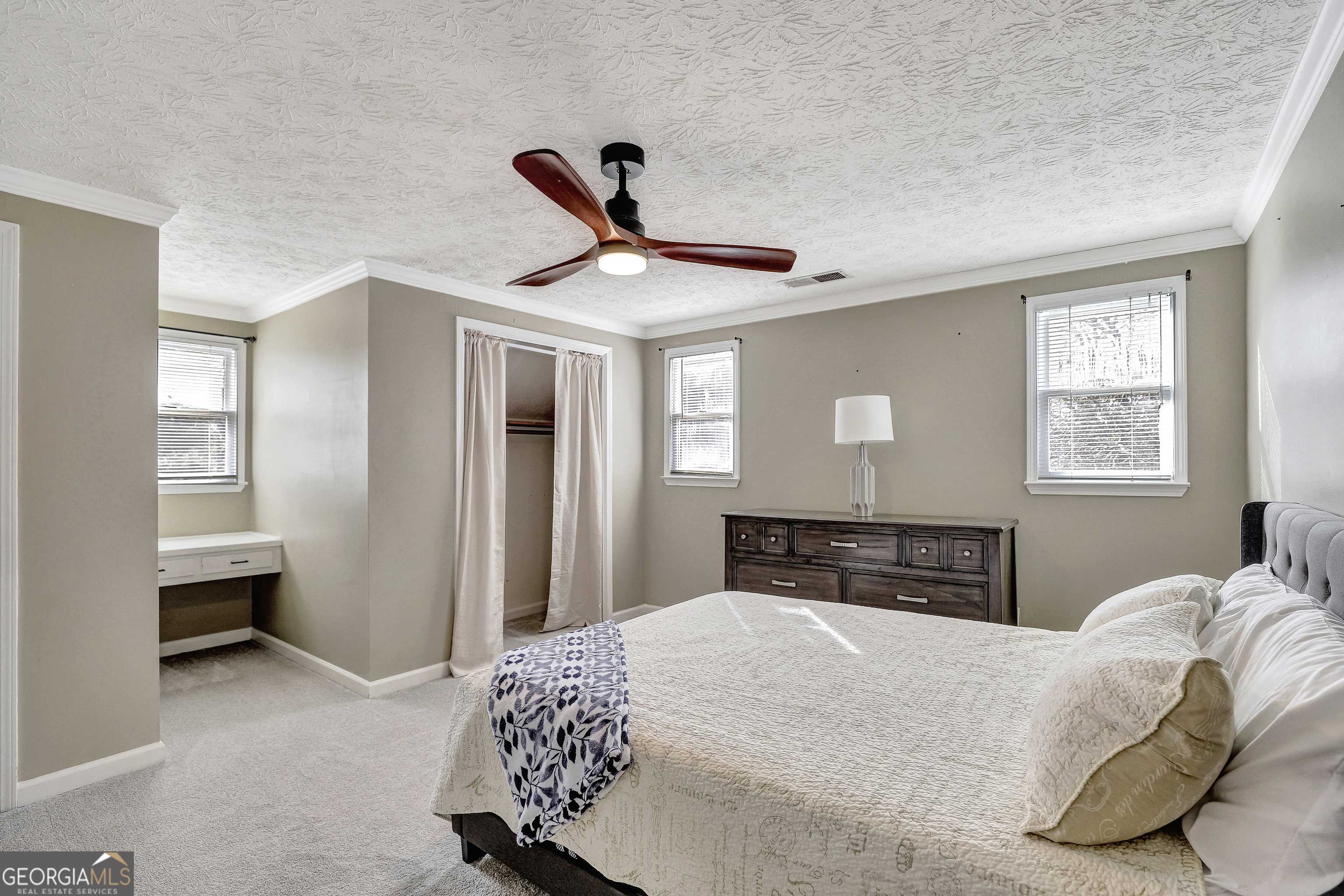 300 Briarwood Road Tyrone, GA 30290 - Photo 36 of 74 a bedroom with a bed and a chandelier