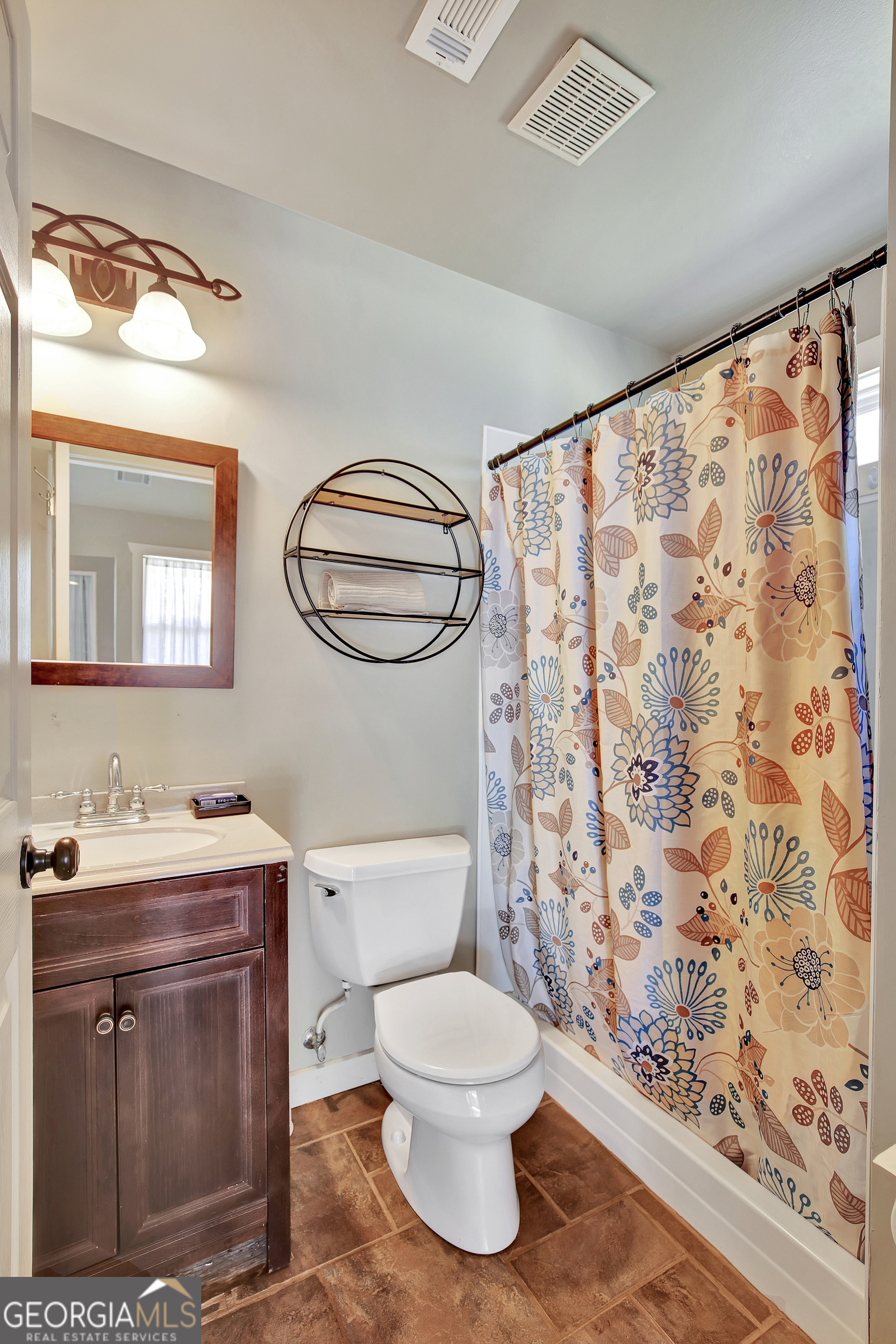 300 Briarwood Road Tyrone, GA 30290 - Photo 41 of 74 a bathroom with a toilet sink and mirror
