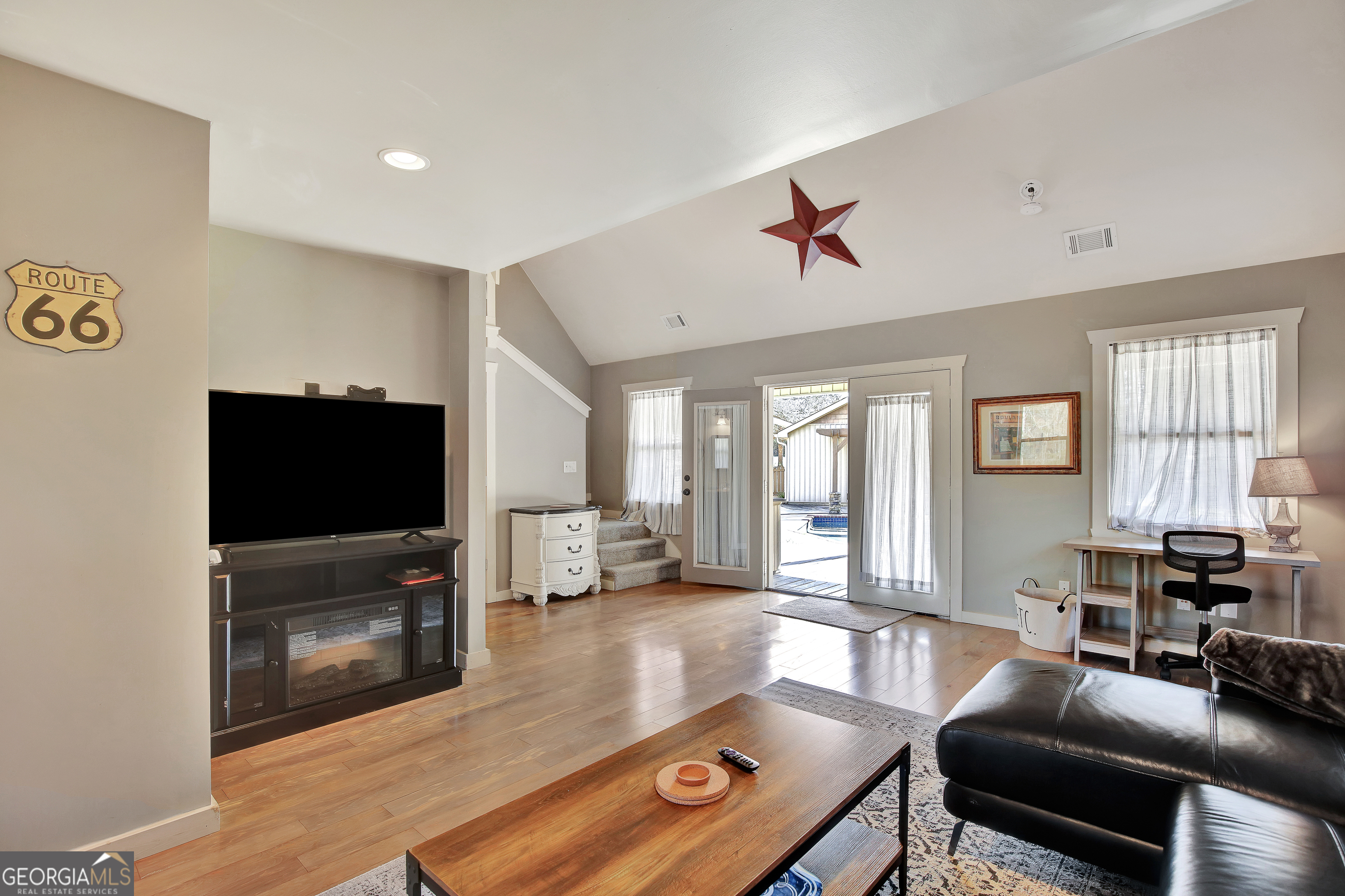300 Briarwood Road Tyrone, GA 30290 - Photo 45 of 74 a living room with furniture and a flat screen tv