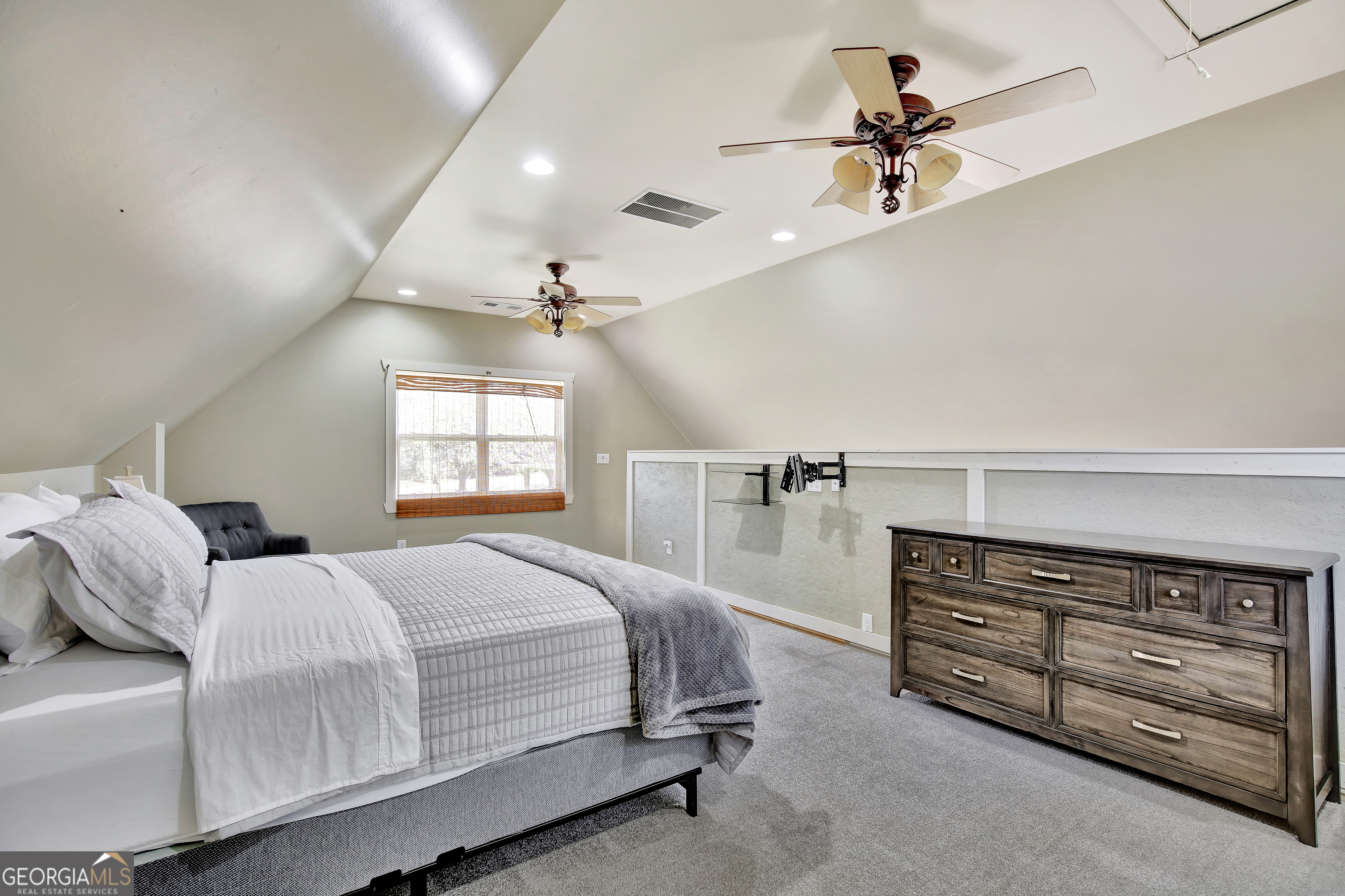 300 Briarwood Road Tyrone, GA 30290 - Photo 52 of 74 a bedroom with a bed a dresser and a chandelier