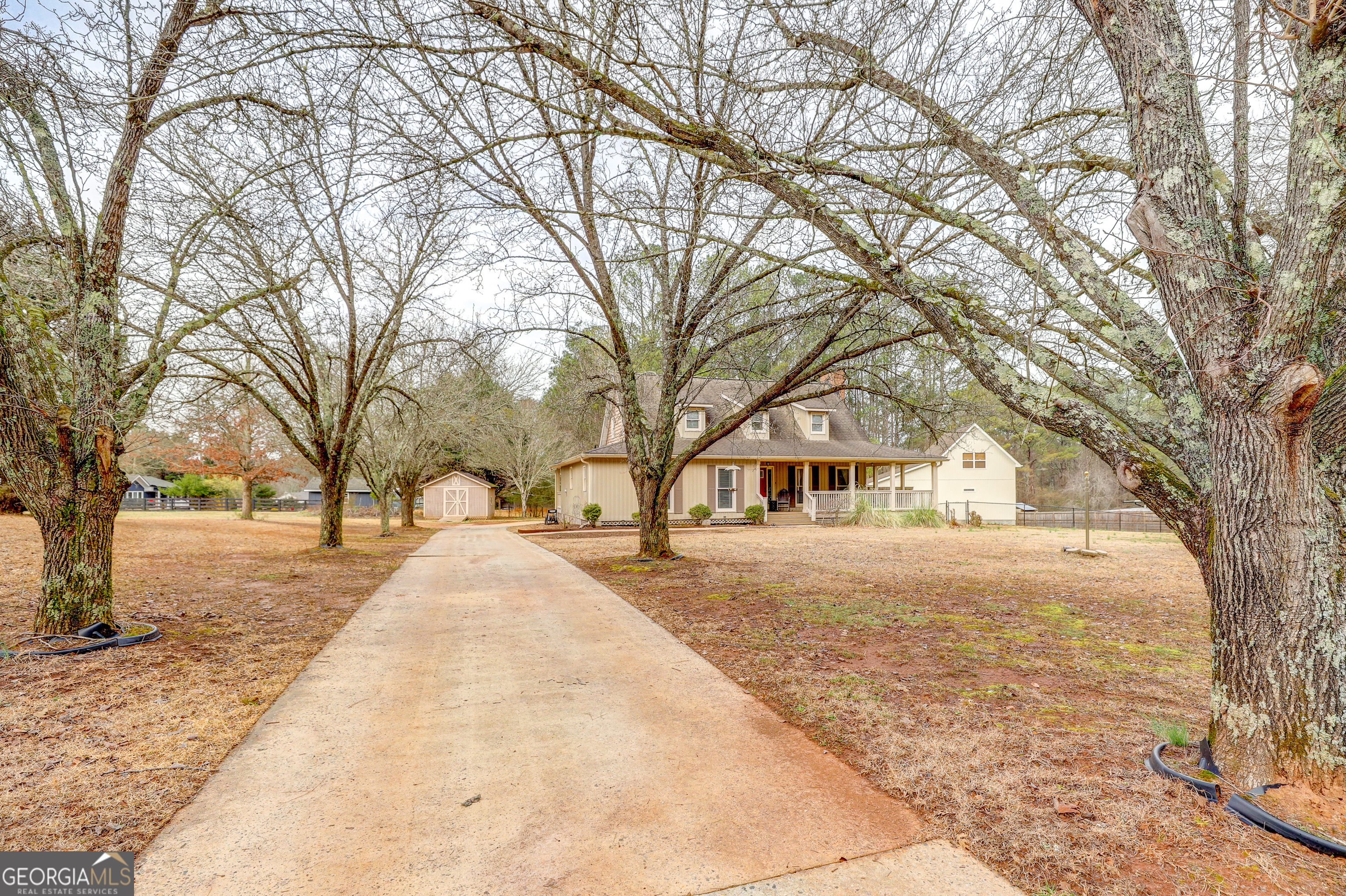 300 Briarwood Road Tyrone, GA 30290 - Photo 61 of 74 a pathway of a house with a yard covered in snow