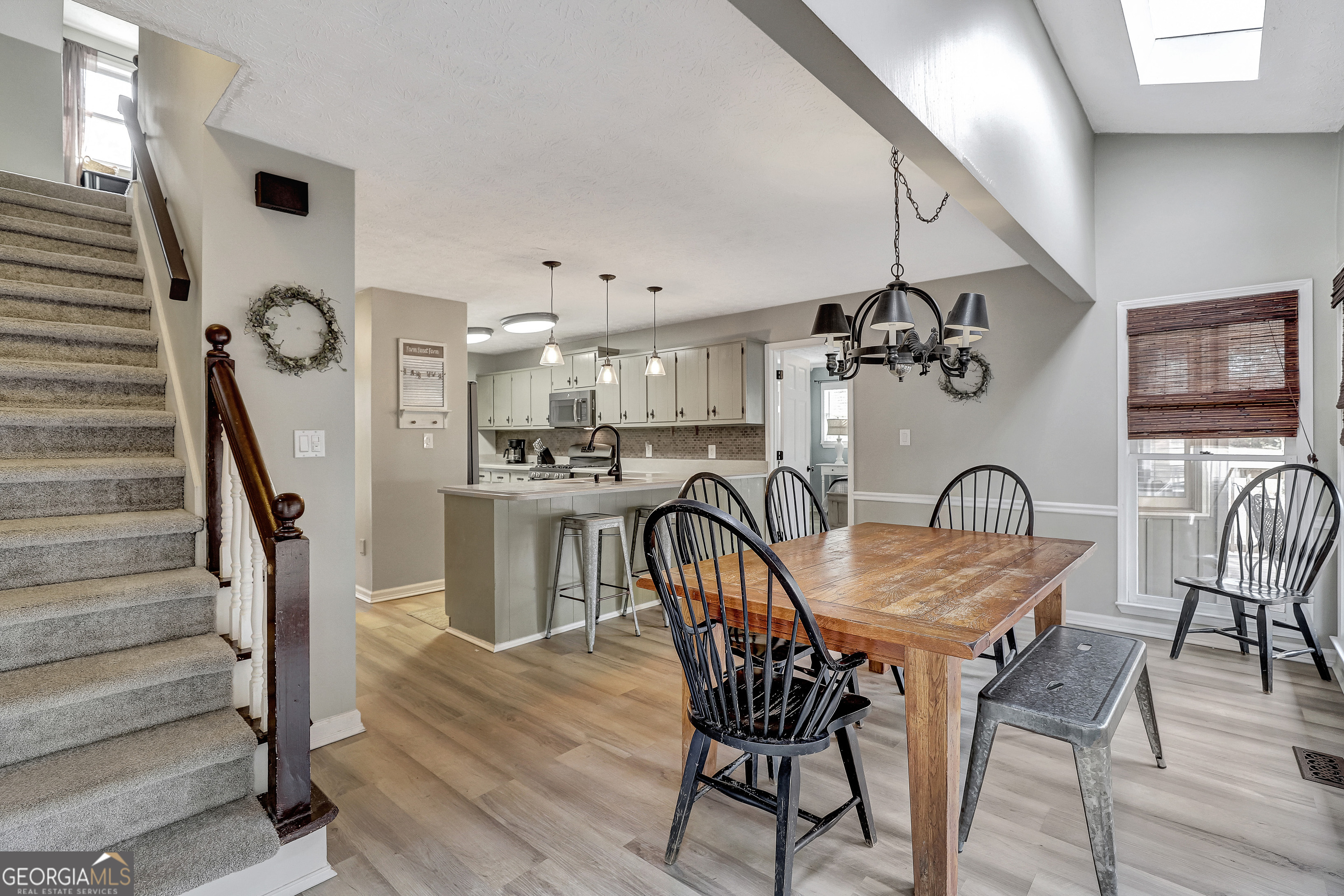 300 Briarwood Road Tyrone, GA 30290 - Photo 10 of 74 a view of a dining room with furniture and wooden floor