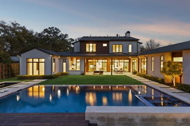 a front view of a house with a yard table and chairs