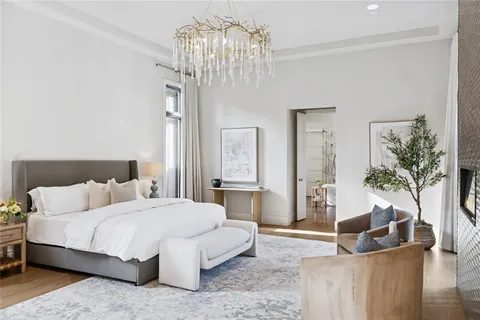 a spacious bedroom with a bed couch and window