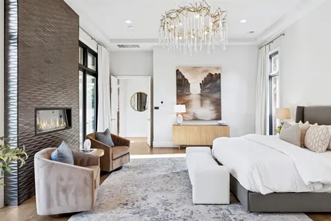 a bedroom with furniture and a fireplace