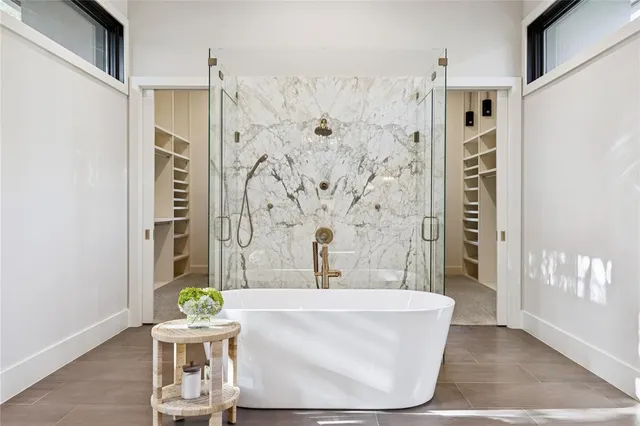 a spacious bathroom with a granite countertop sink and a mirror