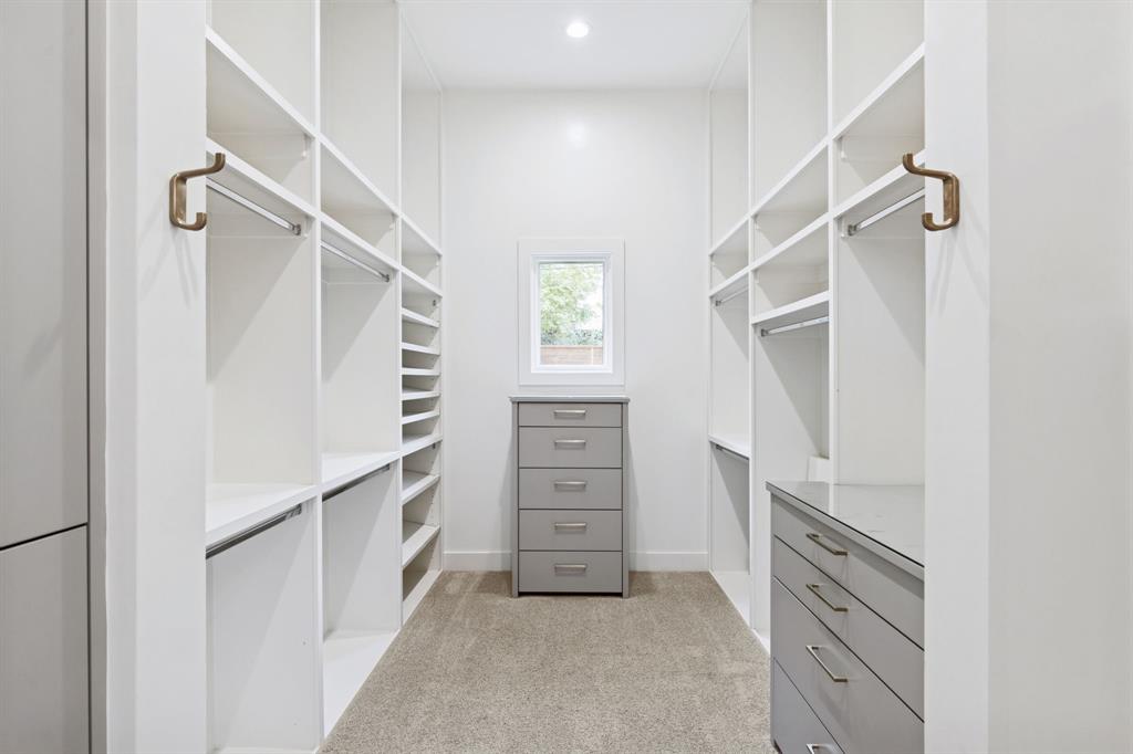 4447 Taos Road Dallas, TX 75209 - Photo 22 of 38 a view of walk in closet with empty racks