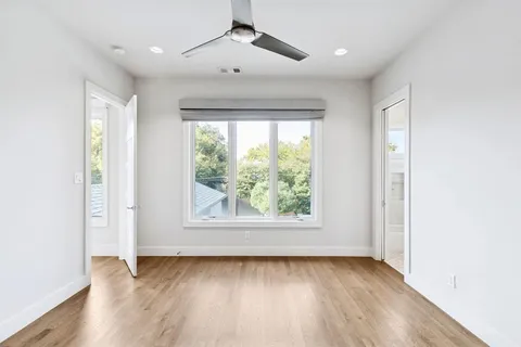 a bathroom with a granite countertop sink a toilet a mirror and bathtub