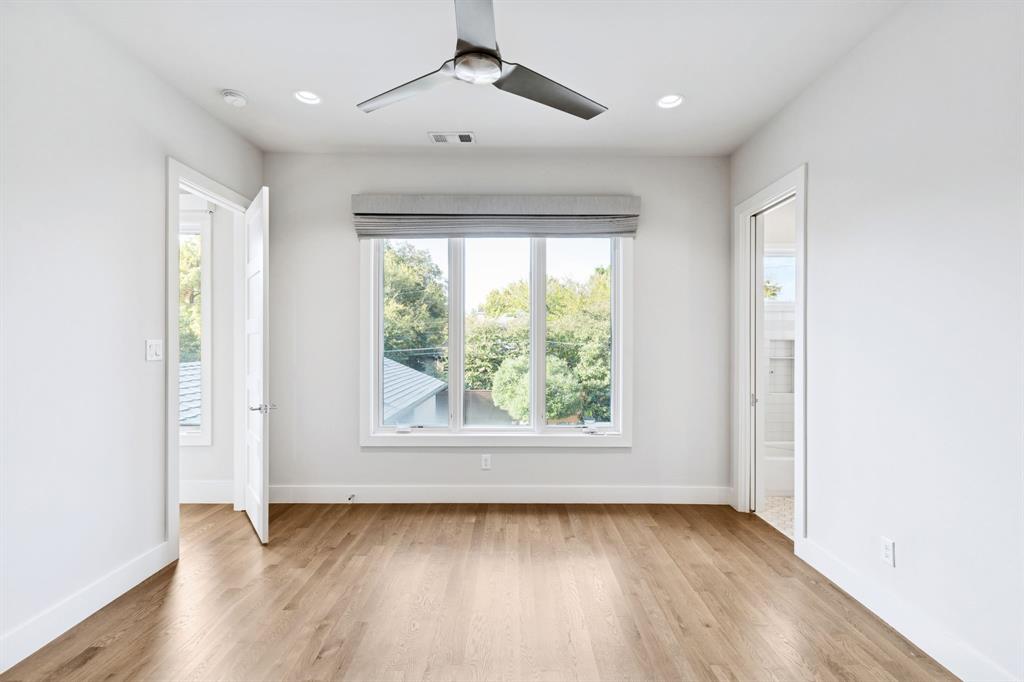 4447 Taos Road Dallas, TX 75209 - Photo 27 of 38 an empty room with wooden floor and windows