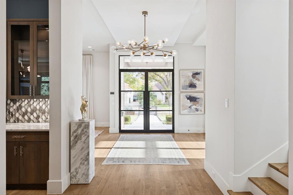 4447 Taos Road Dallas, TX 75209 - Photo 4 of 38 a view of a hallway with windows and chandelier