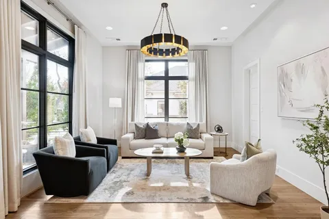 a living room with furniture and a chandelier