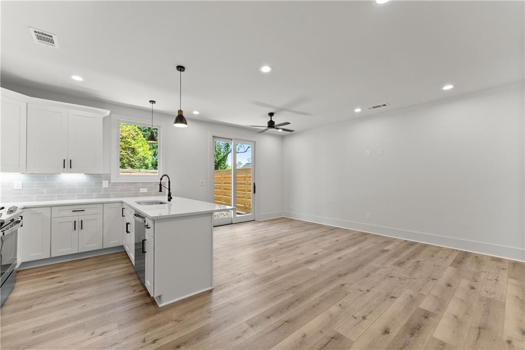 372 Forrest Avenue Gainesville, GA 30501 - Photo 17 of 29 a large kitchen with granite countertop a sink a counter space appliances and cabinets