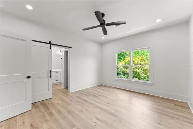 an empty room with windows and closet