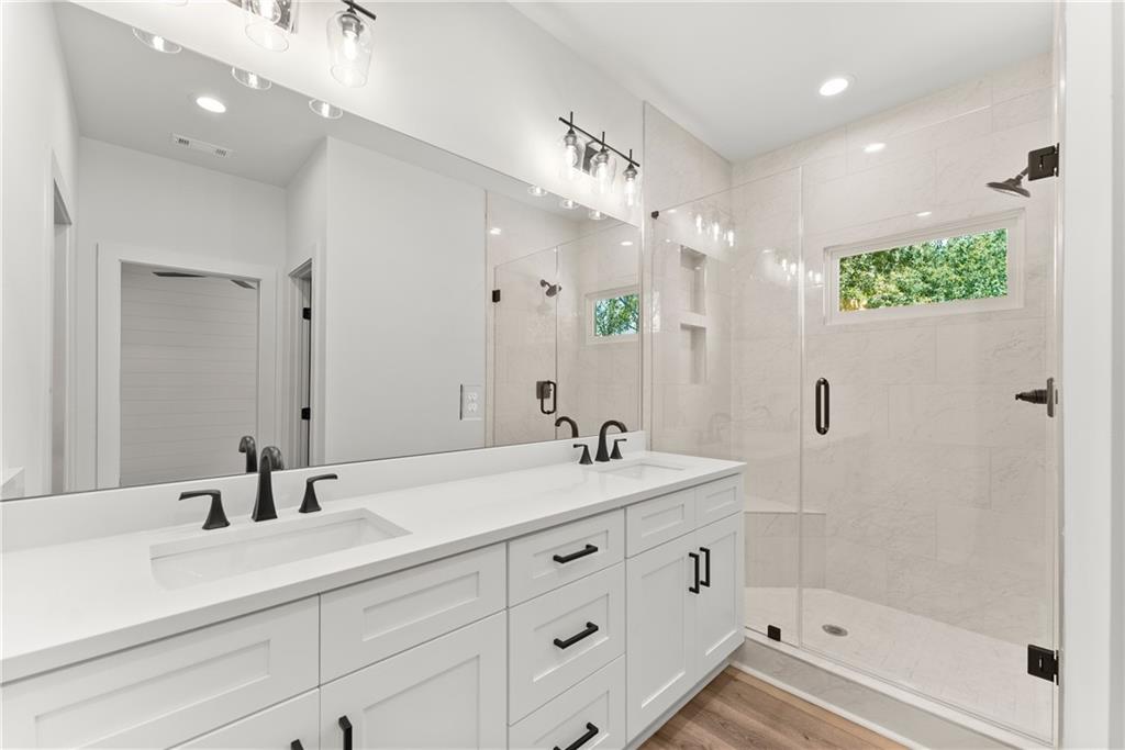 372 Forrest Avenue Gainesville, GA 30501 - Photo 22 of 29 a bathroom with a sink double vanity granite tub shower and a mirror