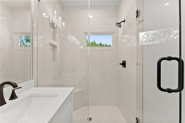 a bathroom with a sink a toilet and shower