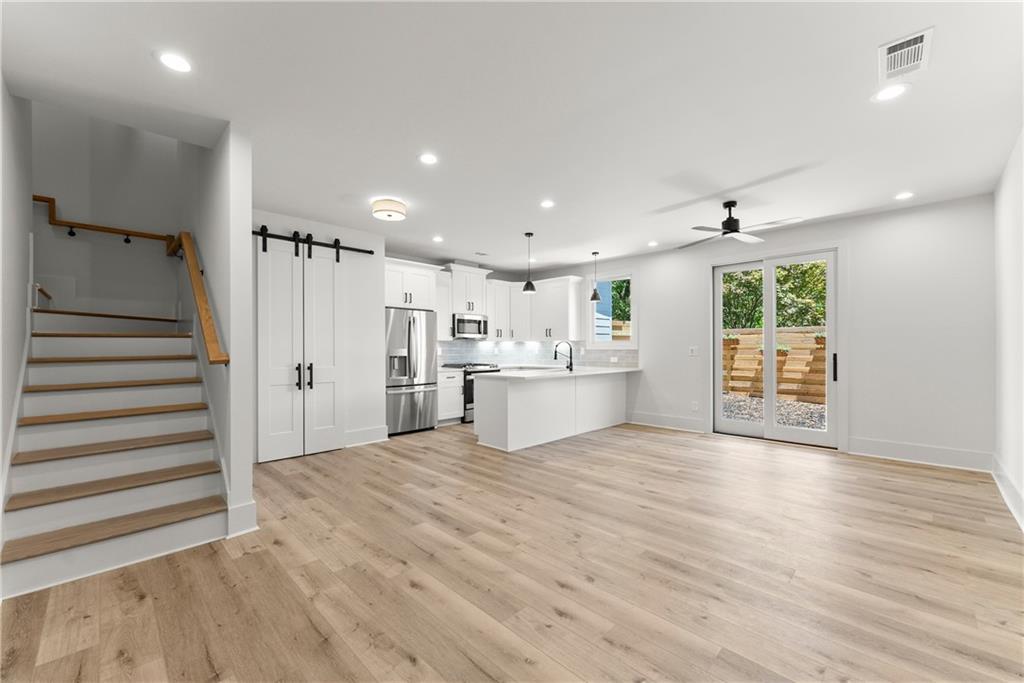 372 Forrest Avenue Gainesville, GA 30501 - Photo 5 of 29 a view of a kitchen with wooden floor and windows