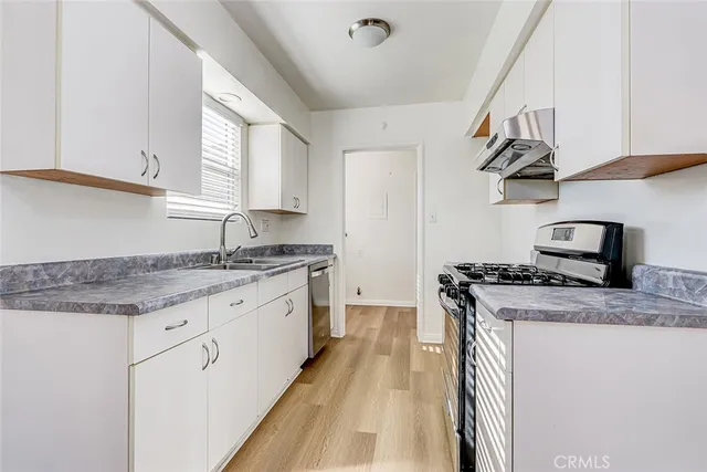 a kitchen with a stove and a sink