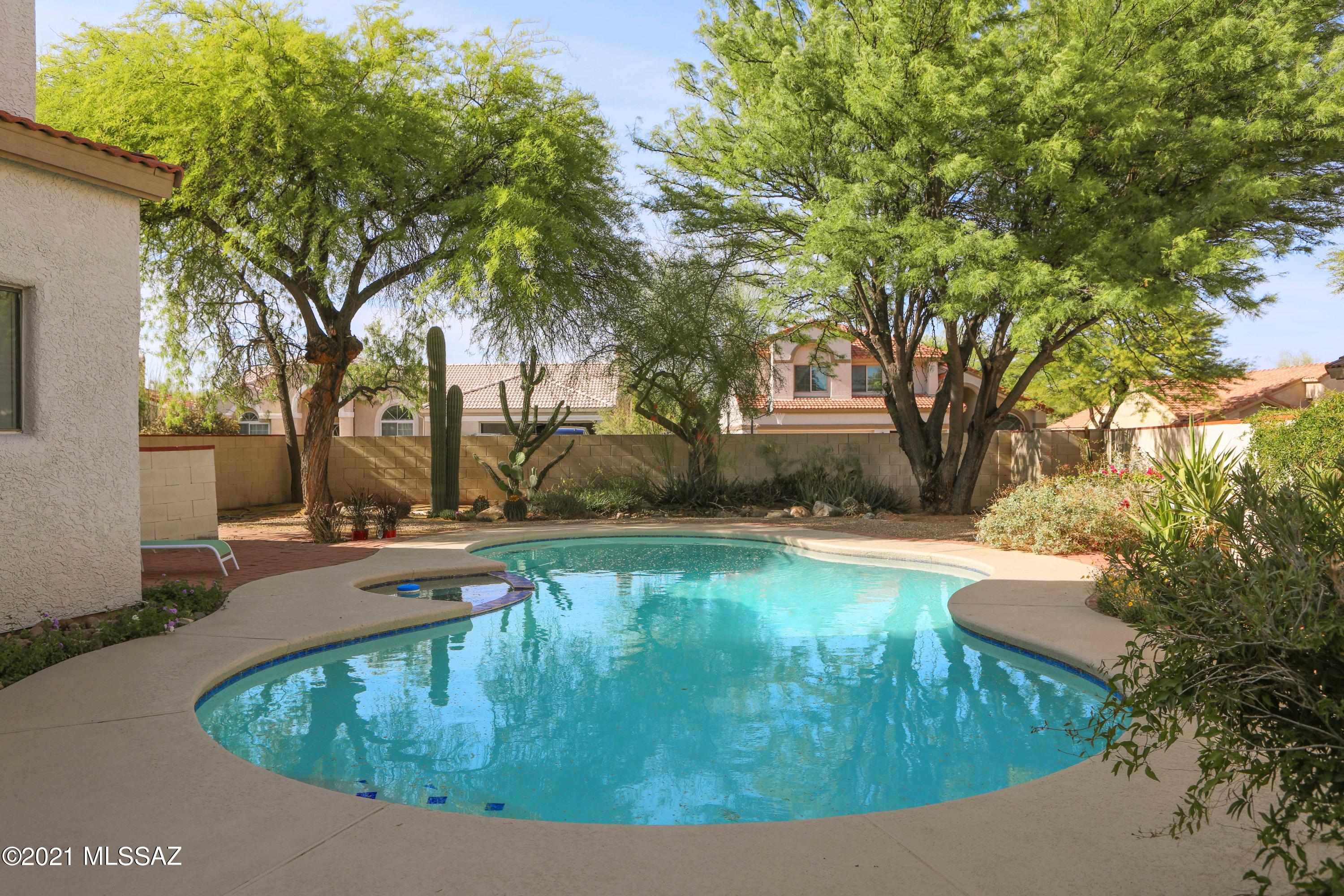 12560 North Wayfarer Way Oro Valley, AZ 85755 - Photo 21 of 43 a view of a swimming pool with outdoor seating