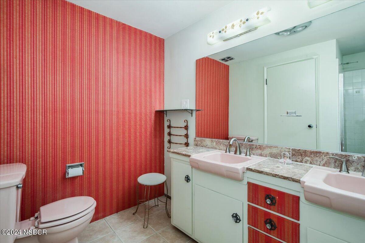 715 South Bradley Road, Unit 25 Santa Maria, CA 93454 - Photo 19 of 28 a bathroom with a sink a toilet a mirror and shower curtain