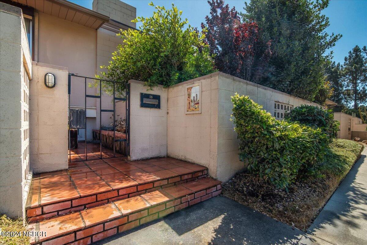 715 South Bradley Road, Unit 25 Santa Maria, CA 93454 - Photo 2 of 28 a backyard of a house with plants and tree