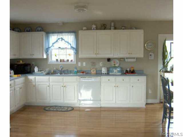 64 Ashburn Road Cumberland, VA 23040 - Photo 3 of 8 a kitchen with granite countertop white cabinets and white appliances