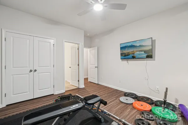 a bathroom with a granite countertop sink a toilet and shower