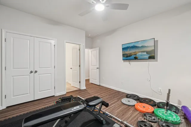 a bathroom with a granite countertop sink a toilet and shower