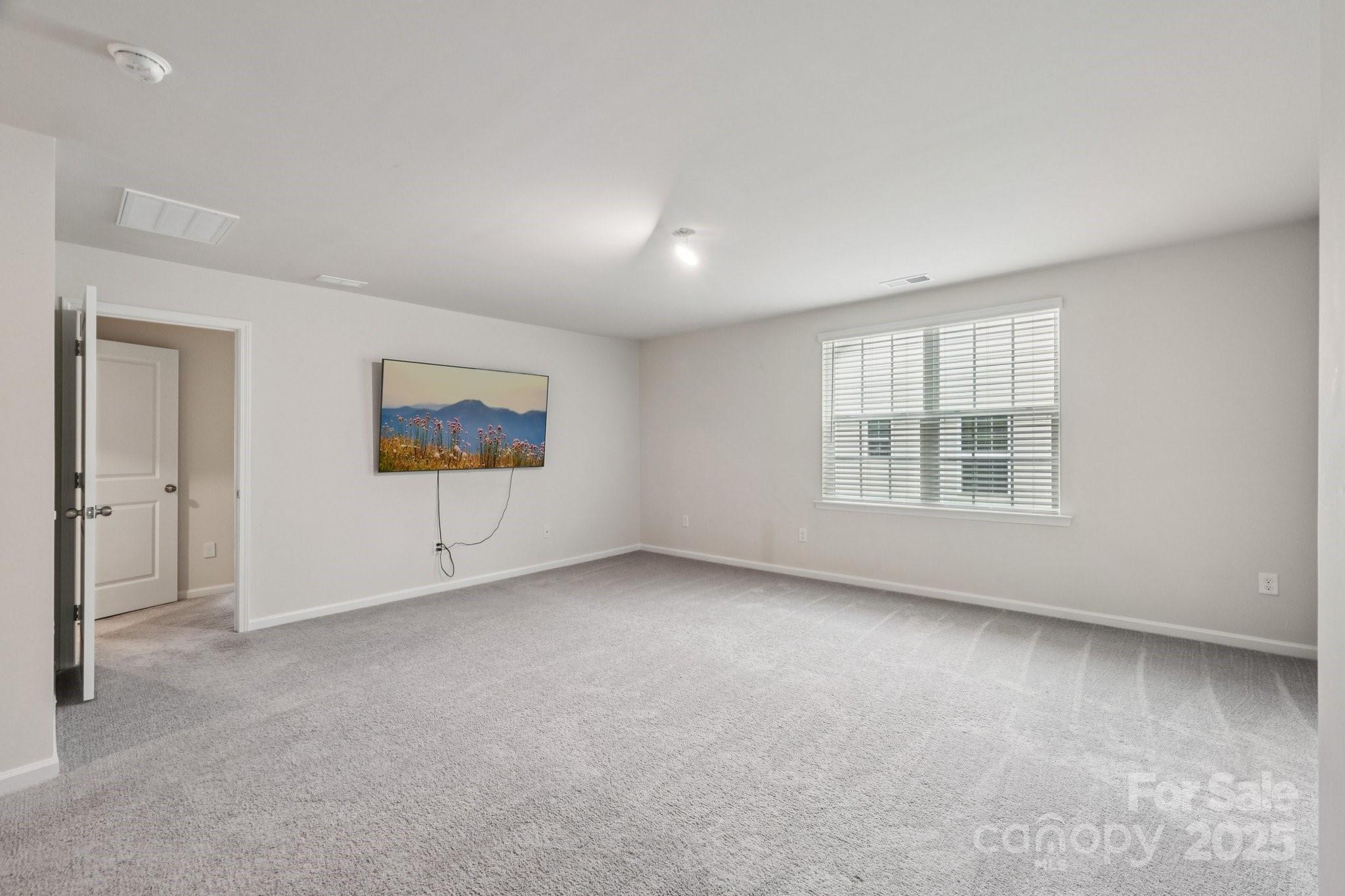 299 Hamptons Cove Road Troutman, NC 28166 - Photo 19 of 40 an empty room with windows