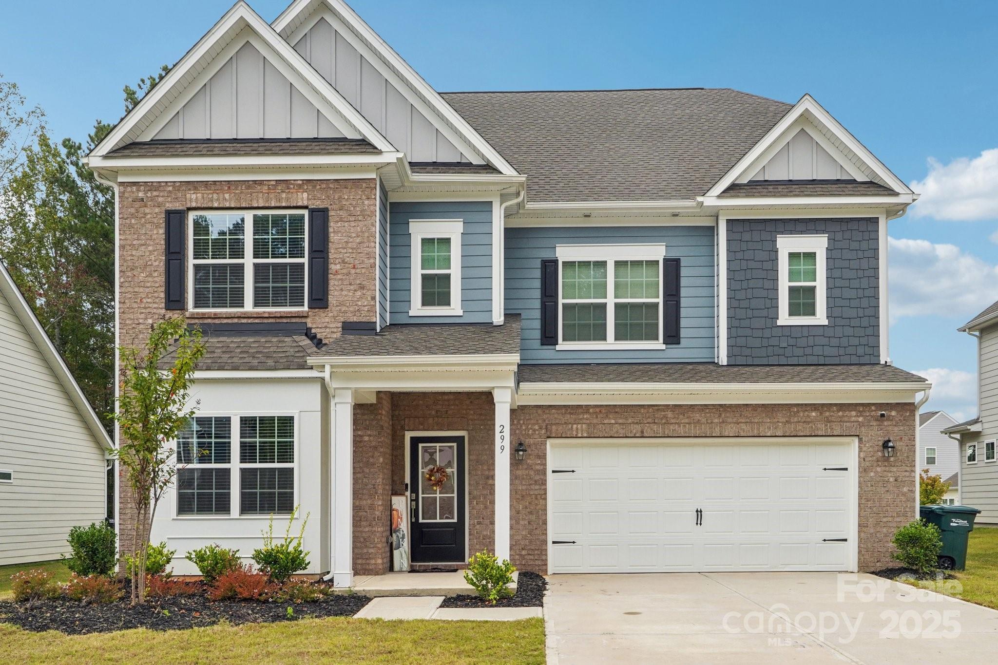 299 Hamptons Cove Road Troutman, NC 28166 - Photo 2 of 40 a front view of a house with garden