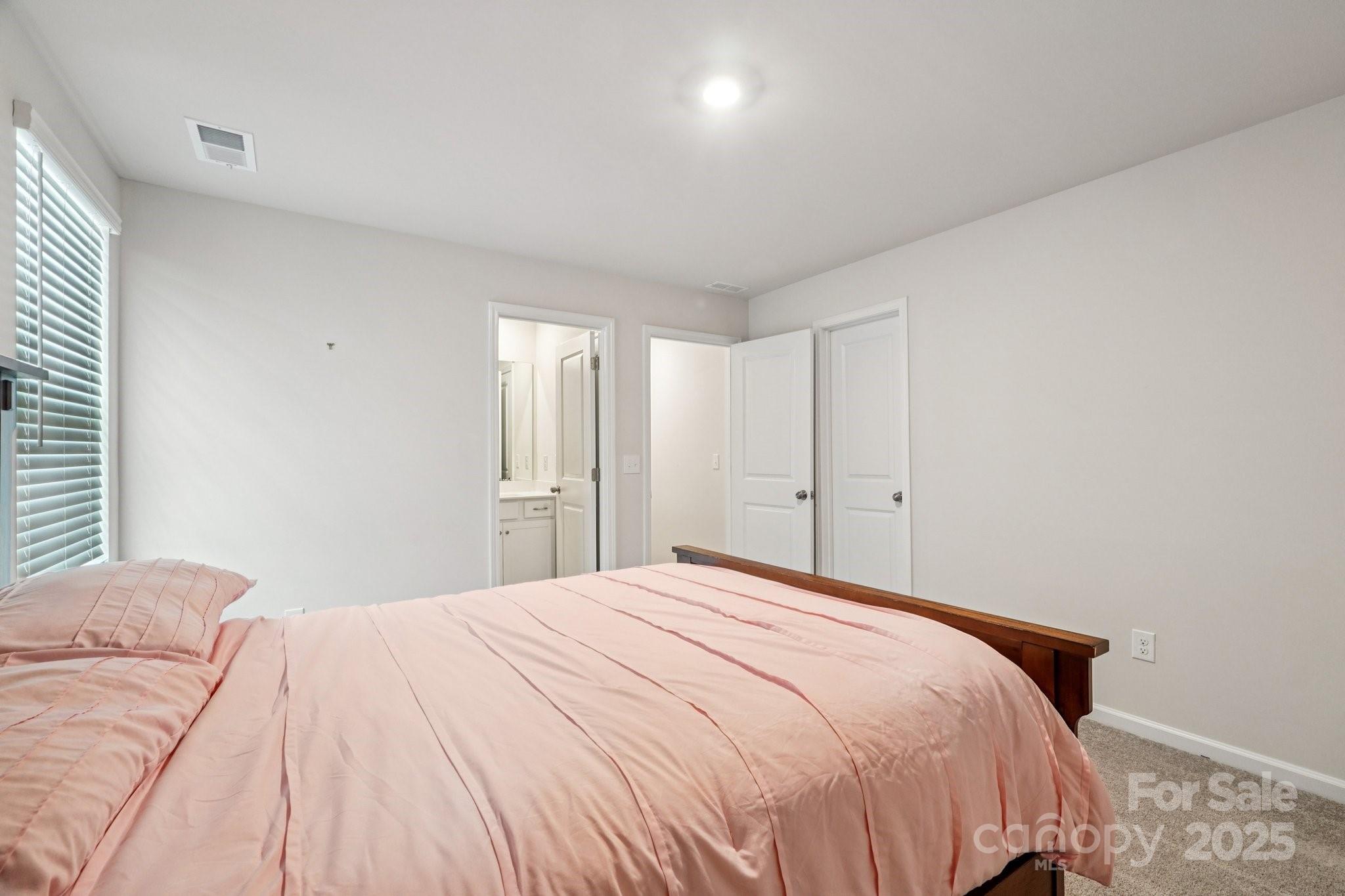 299 Hamptons Cove Road Troutman, NC 28166 - Photo 24 of 40 a bedroom with a bed and a window