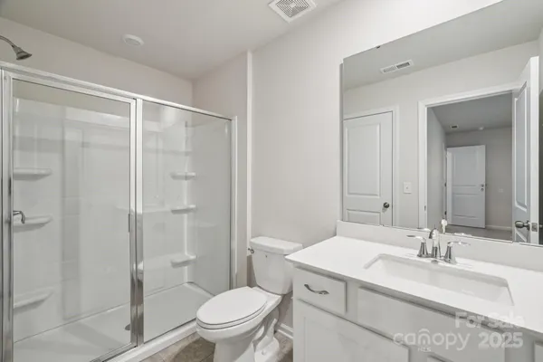 a en suite bathroom with a sink a toilet and shower