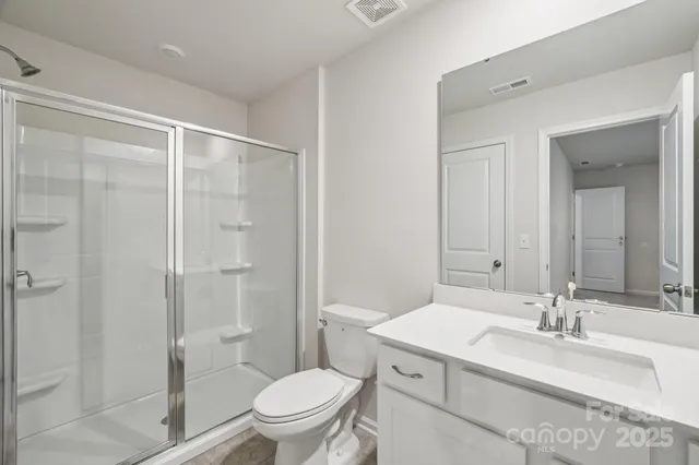 a en suite bathroom with a sink a toilet and shower