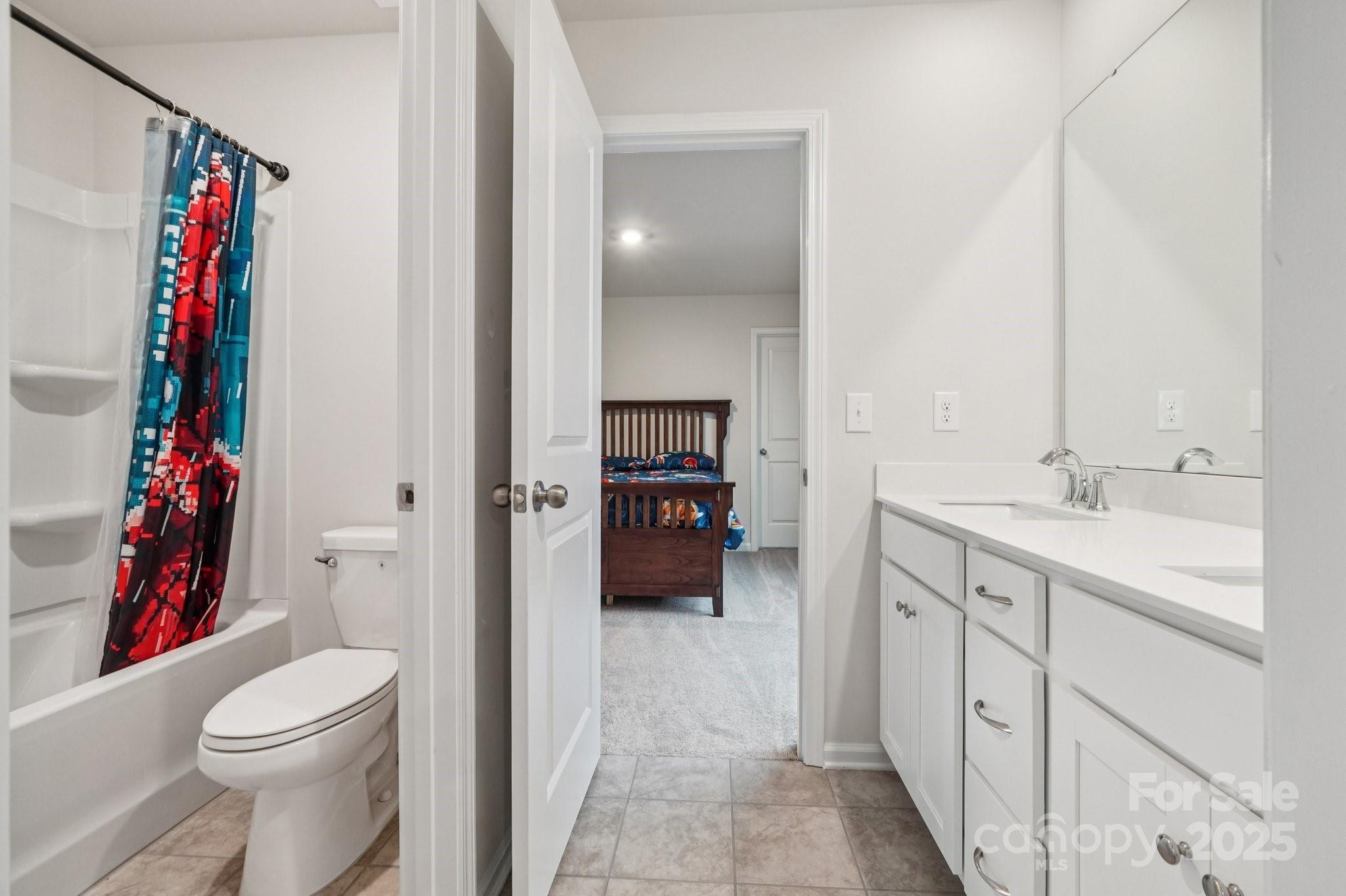 299 Hamptons Cove Road Troutman, NC 28166 - Photo 26 of 40 a en suite bathroom with a sink a toilet and shower