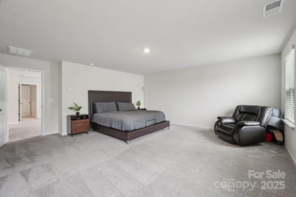 a living room with a dresser and a window